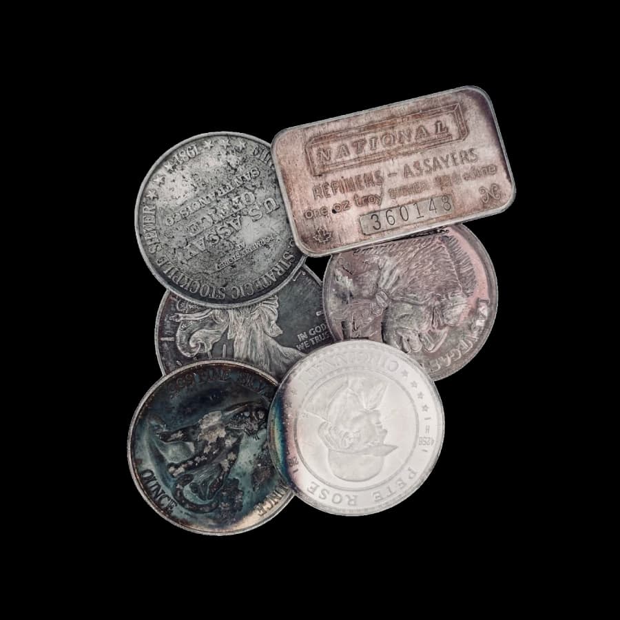 Assorted secondary-market 1 oz generic silver rounds showing toning, spotting, and surface wear